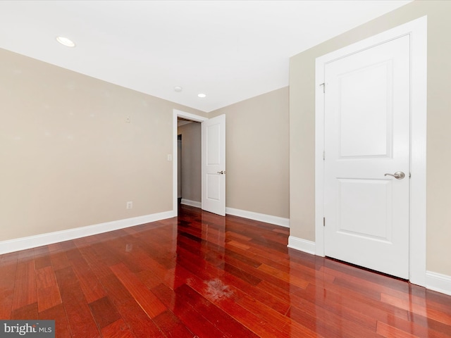 unfurnished room with hardwood / wood-style floors