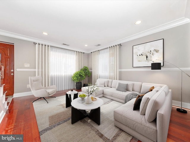 living room with crown molding and dark hardwood / wood-style floors