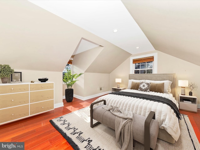 bedroom with hardwood / wood-style flooring and lofted ceiling