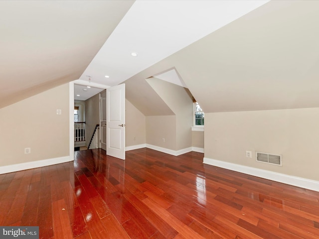 additional living space featuring wood-type flooring and lofted ceiling