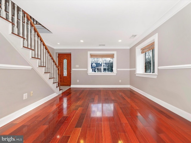 interior space featuring wood-type flooring, a wealth of natural light, and ornamental molding