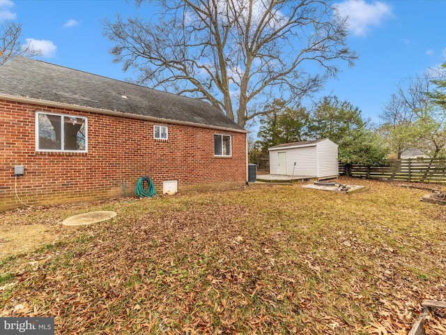 view of yard with a storage unit and central AC