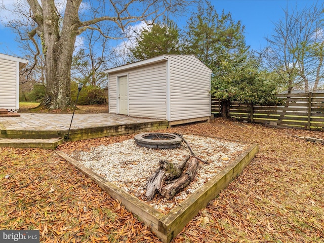 exterior space with a shed and a fire pit