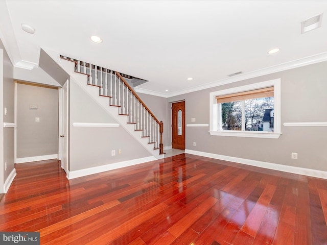 entryway featuring wood-type flooring and ornamental molding