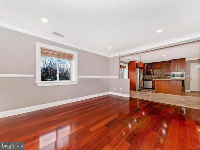 unfurnished living room with crown molding and dark wood-type flooring