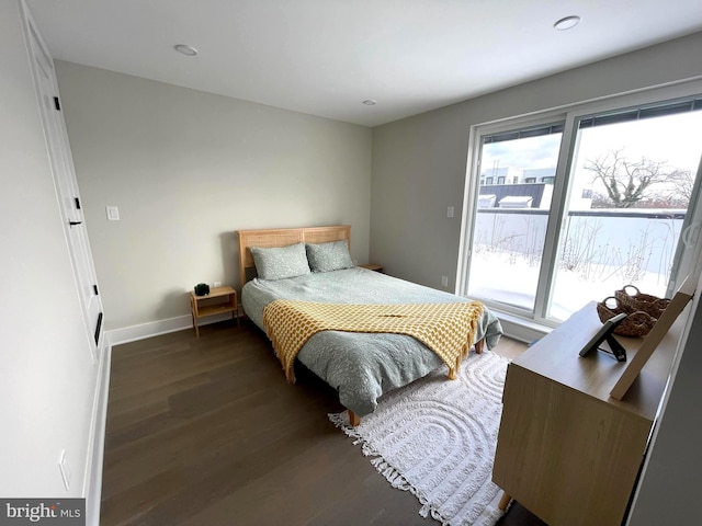 bedroom with dark hardwood / wood-style floors