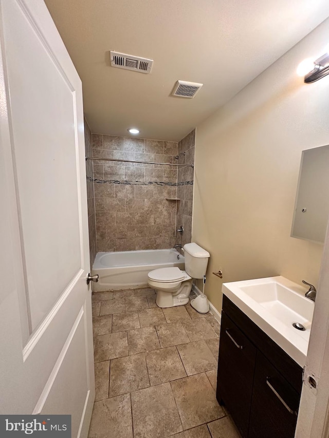 full bathroom featuring vanity, toilet, and tiled shower / bath