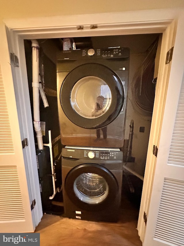 laundry area featuring stacked washer / drying machine