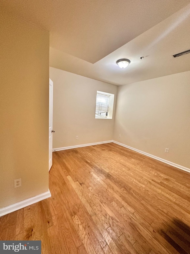 unfurnished room with light hardwood / wood-style flooring