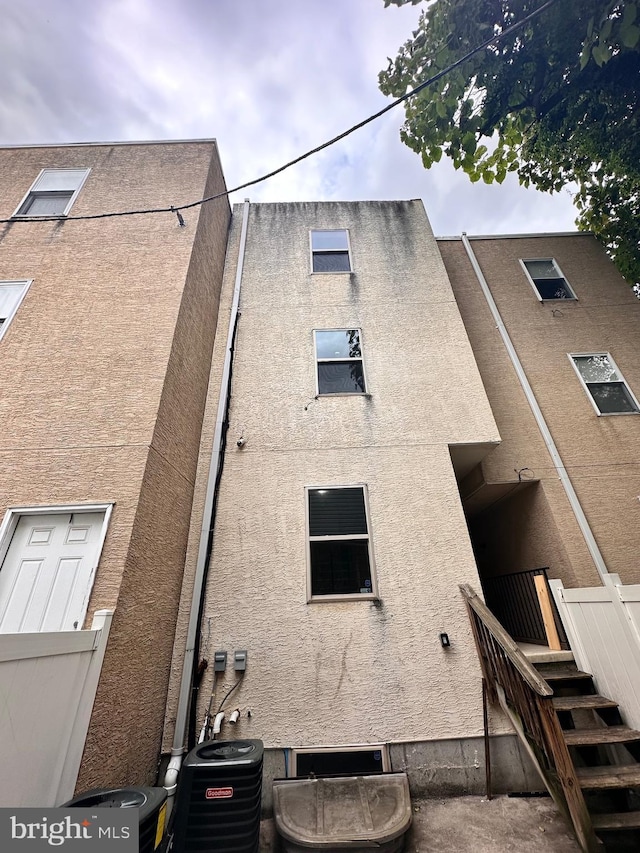 back of house with central AC unit