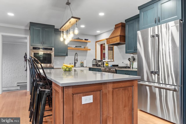 kitchen with custom exhaust hood, decorative light fixtures, a kitchen island, a kitchen bar, and stainless steel appliances