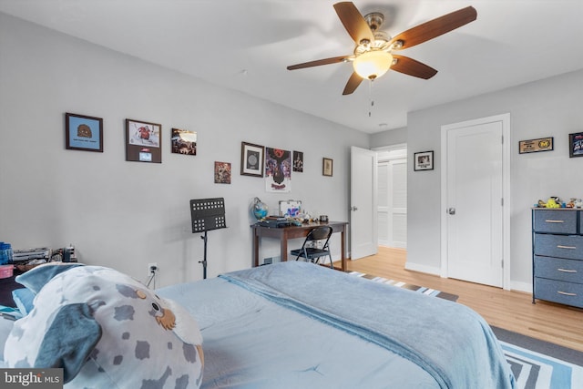 bedroom with hardwood / wood-style floors and ceiling fan