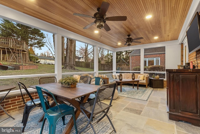 sunroom featuring ceiling fan and wooden ceiling