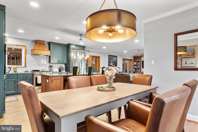 dining area featuring ceiling fan, light hardwood / wood-style flooring, and ornamental molding