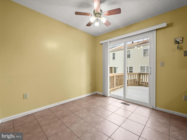 unfurnished room featuring ceiling fan, a textured ceiling, and light tile patterned flooring