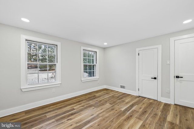 empty room with hardwood / wood-style flooring