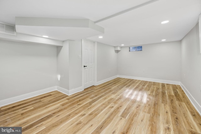 basement with light hardwood / wood-style floors