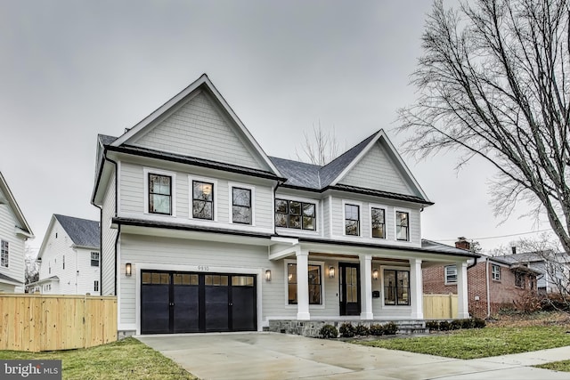 view of front of house featuring a porch and a garage