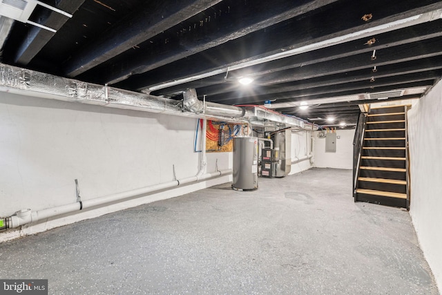 basement featuring electric water heater, electric panel, and heating unit