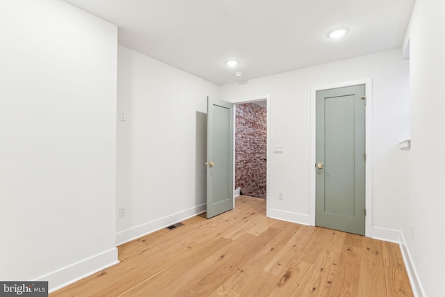 unfurnished bedroom featuring light wood-type flooring