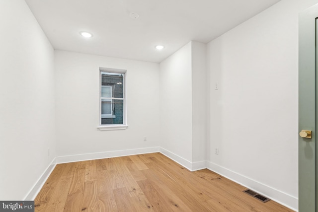 empty room with hardwood / wood-style floors