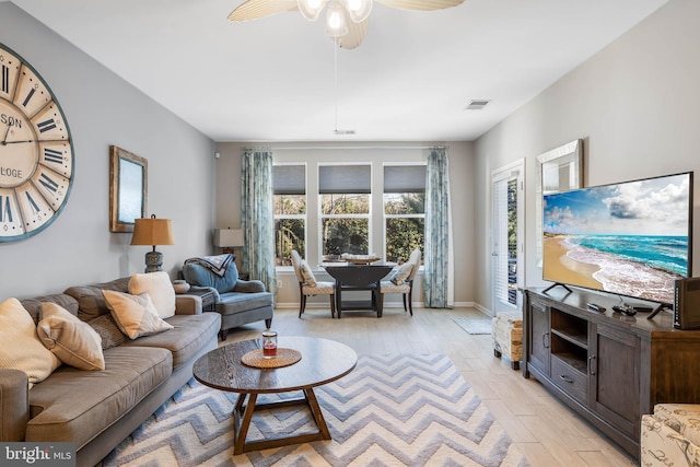 living room featuring light hardwood / wood-style flooring and ceiling fan