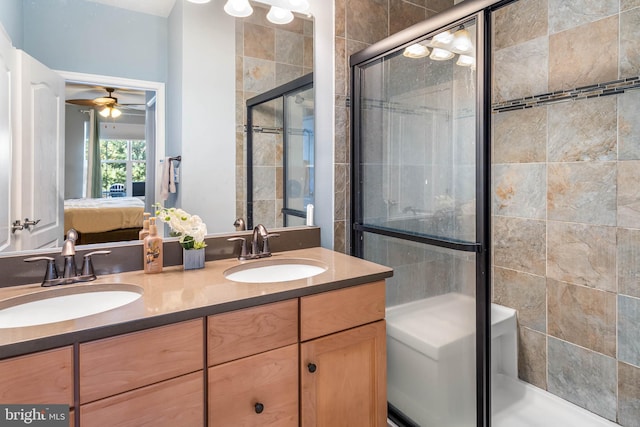 bathroom featuring walk in shower, vanity, and ceiling fan