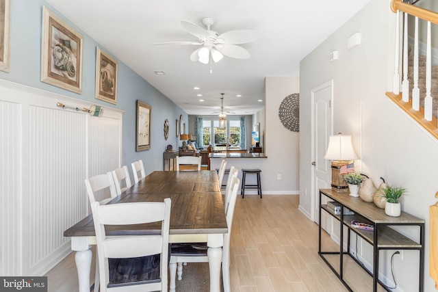 dining area with ceiling fan and light hardwood / wood-style floors