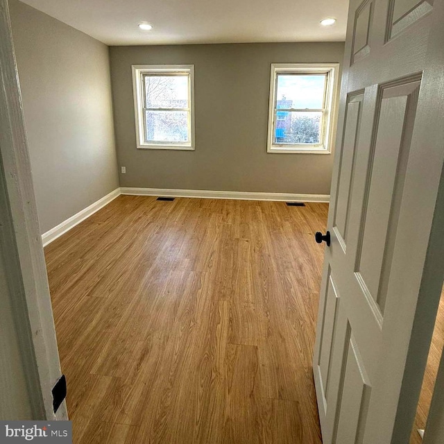 spare room featuring light hardwood / wood-style flooring