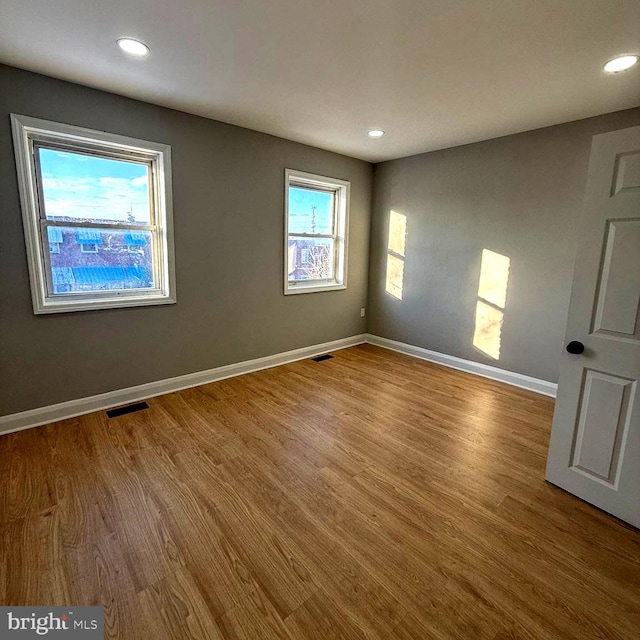 spare room with light hardwood / wood-style flooring