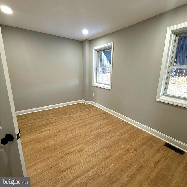 spare room featuring light hardwood / wood-style flooring