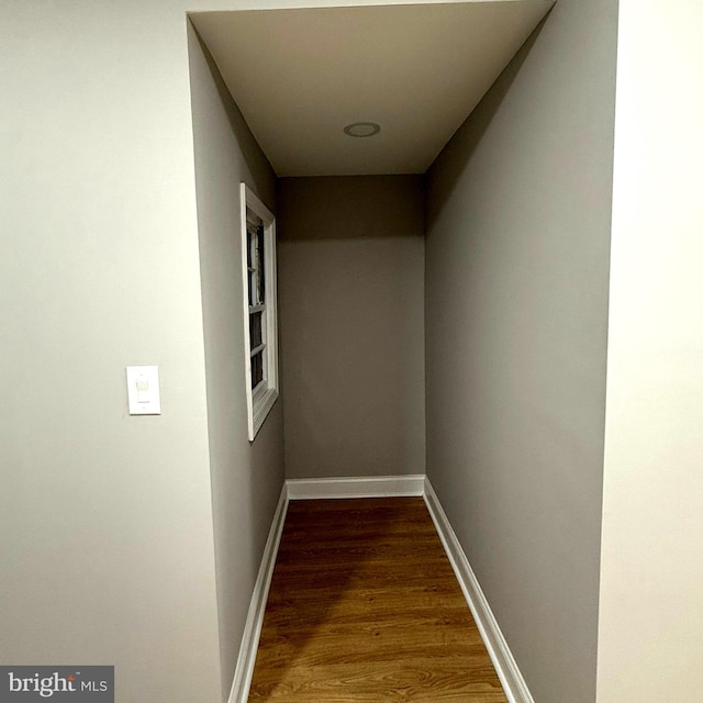 corridor with wood-type flooring