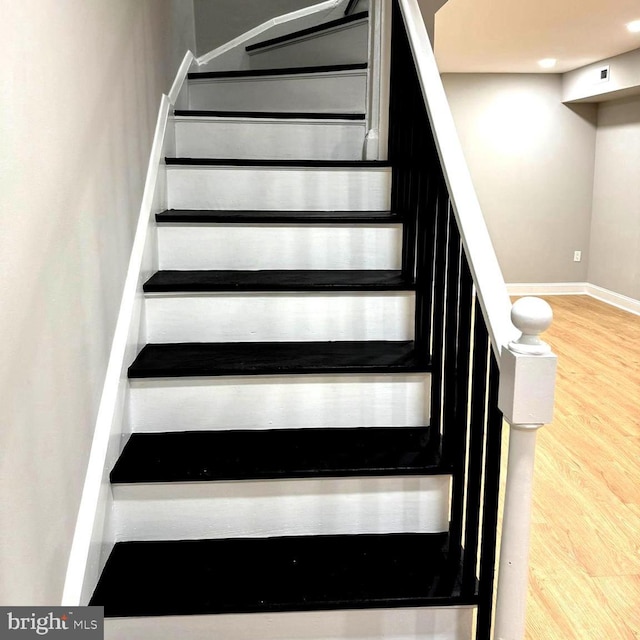 staircase featuring hardwood / wood-style floors