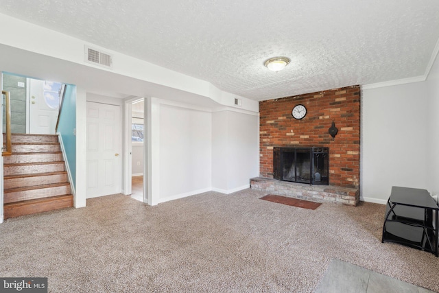 living room featuring carpet flooring, crown molding, a textured ceiling, and a brick fireplace