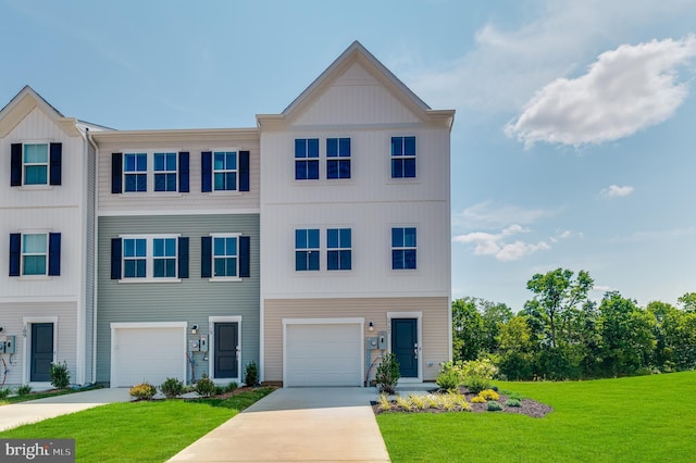 view of property with a garage and a front lawn