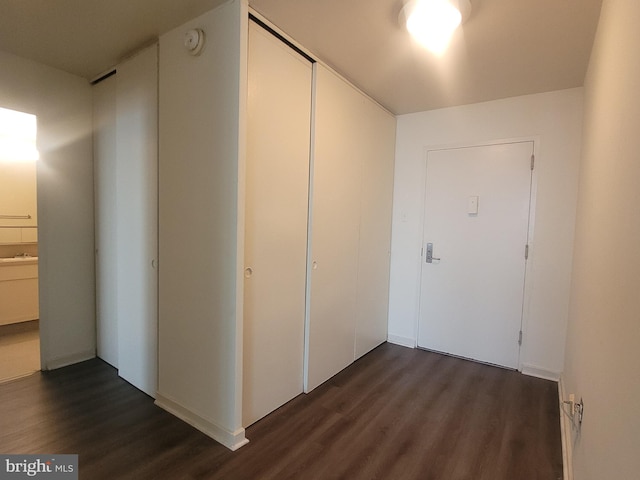 corridor featuring dark hardwood / wood-style floors and sink