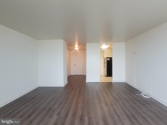 unfurnished living room with dark hardwood / wood-style flooring