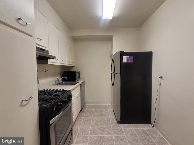 kitchen with appliances with stainless steel finishes, white cabinetry, and sink