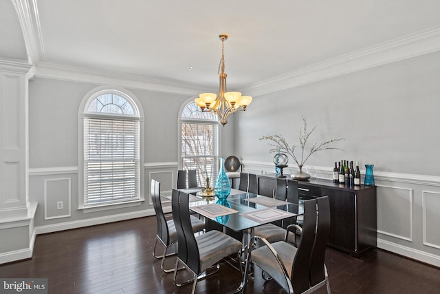 dining room featuring an inviting chandelier, ornamental molding, and dark hardwood / wood-style flooring