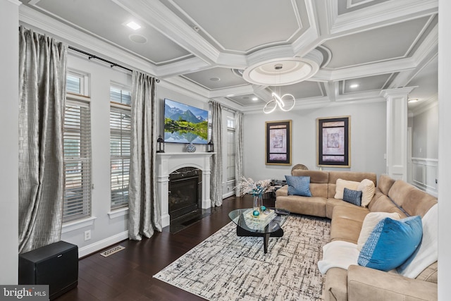 living room featuring ornamental molding, dark hardwood / wood-style flooring, coffered ceiling, and ornate columns