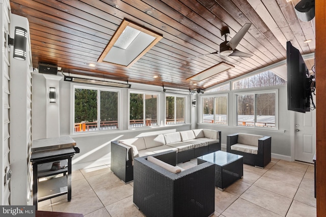 sunroom with ceiling fan, vaulted ceiling, and wood ceiling