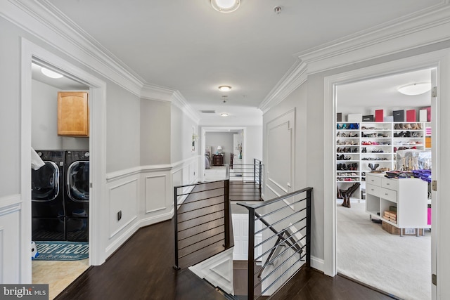 hall with washing machine and clothes dryer and ornamental molding