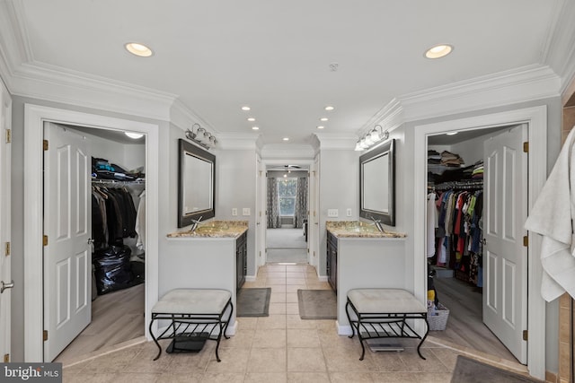 interior space featuring vanity, tile patterned floors, and crown molding