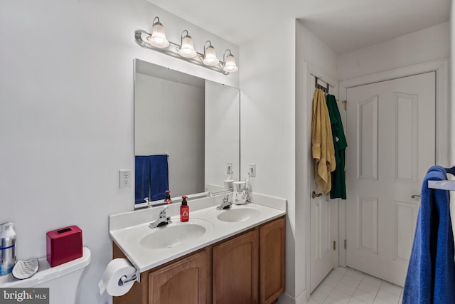 bathroom featuring toilet, tile patterned flooring, and vanity