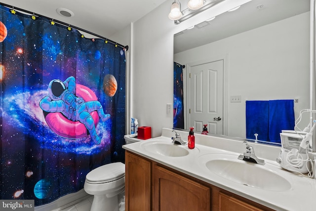 bathroom featuring a shower with shower curtain, vanity, tile patterned floors, and toilet