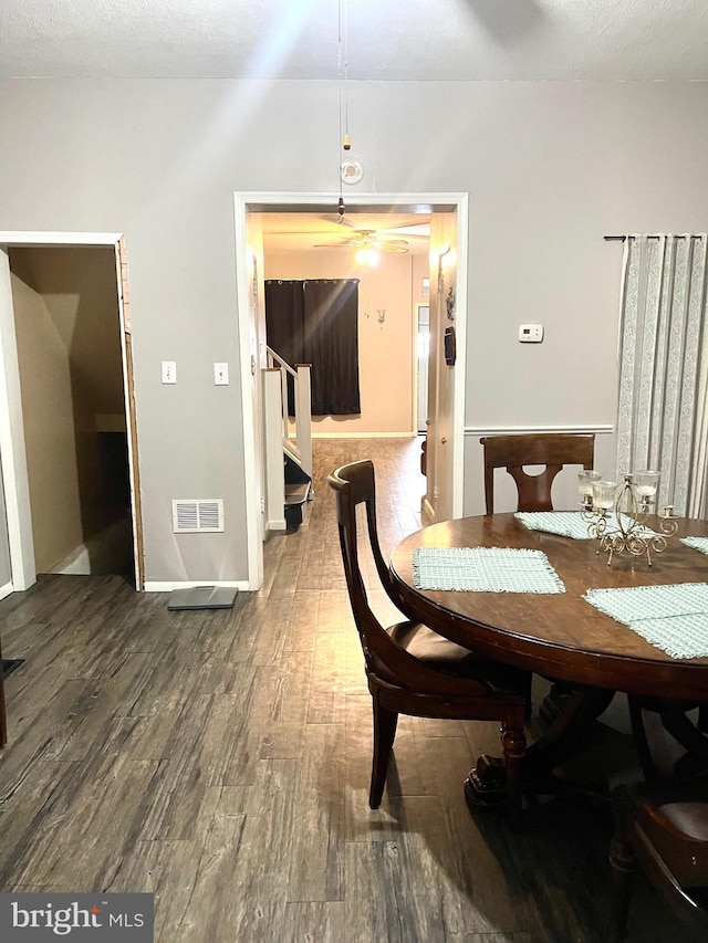 dining space with ceiling fan and hardwood / wood-style flooring