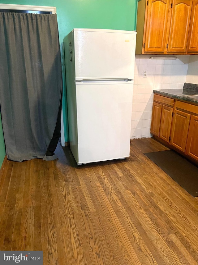 kitchen with hardwood / wood-style floors and white fridge