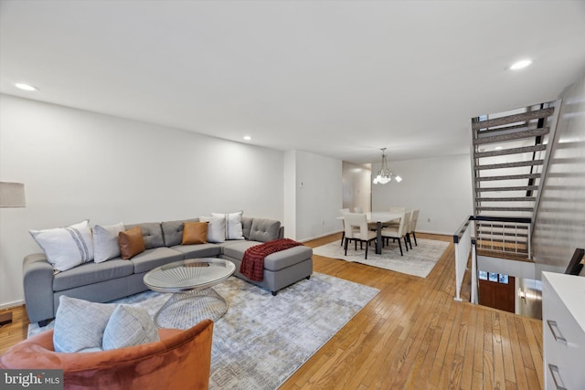 living room with a notable chandelier and light hardwood / wood-style flooring