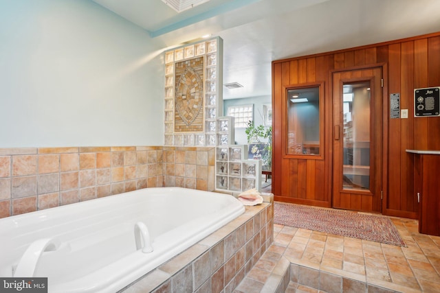 bathroom featuring a relaxing tiled tub