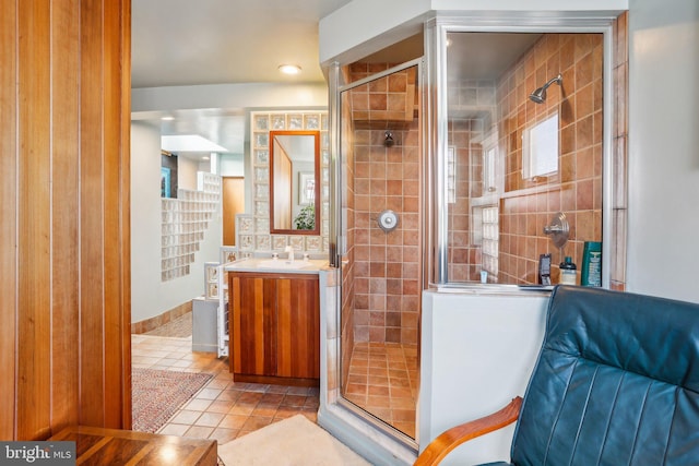 bathroom with tile patterned floors, vanity, and a shower with shower door